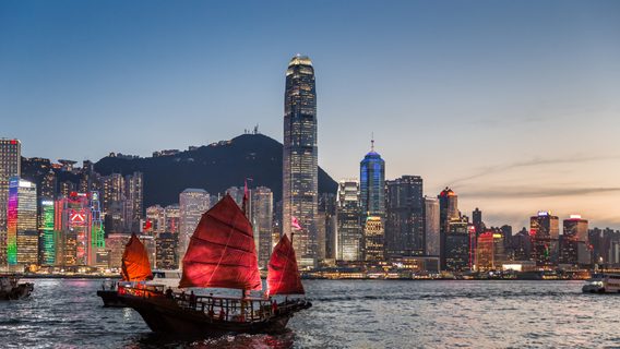 Traditional junk boat sailing across Victoria Harbour, Hong Kong.