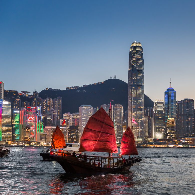 Traditional junk boat sailing across Victoria Harbour, Hong Kong.