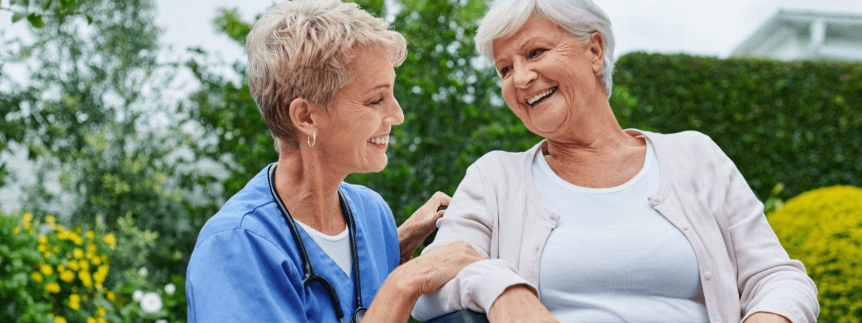 two women with short hair smiling