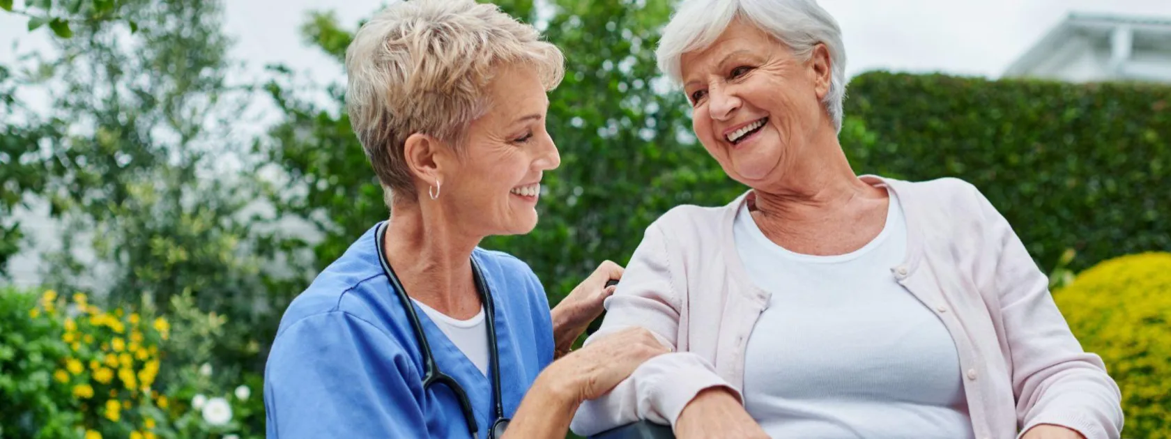 two women with short hair smiling