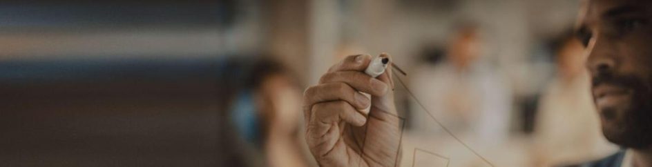 man looking at a marker pen