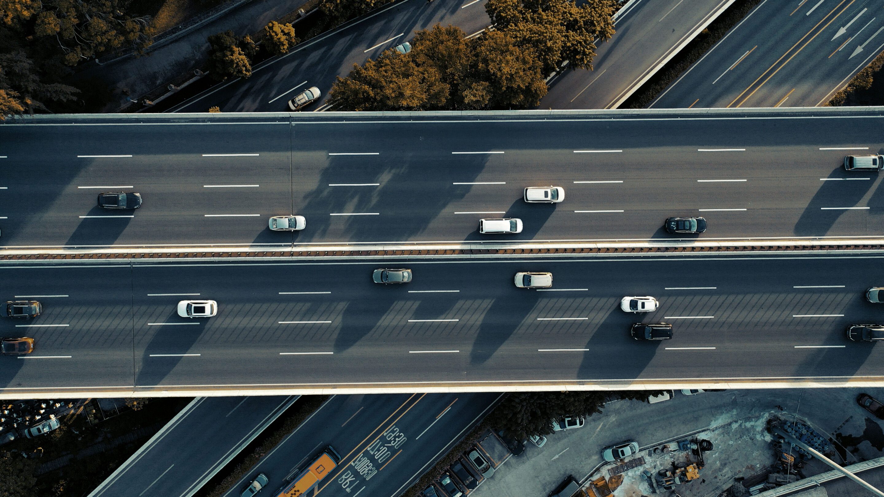 Aerial view of vehicles travelling on a multi-lane highway interchange.