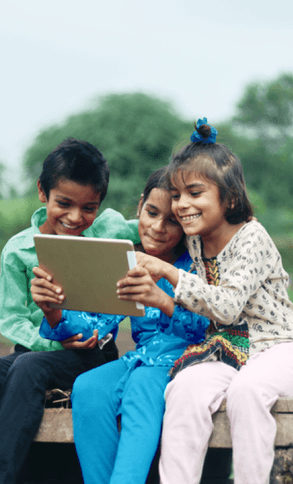 Children play together on an iPad.