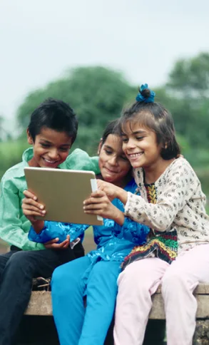 Children play together on an iPad.