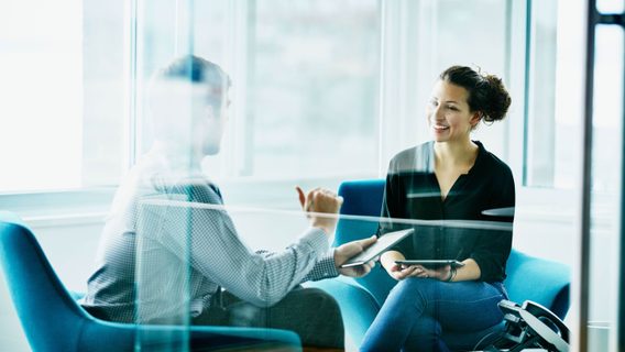 Two people discussing in a meeting room