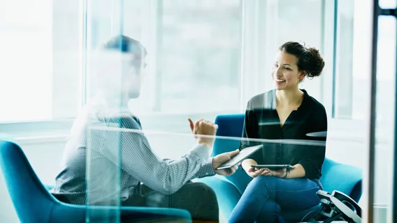 Two people discussing in a meeting room