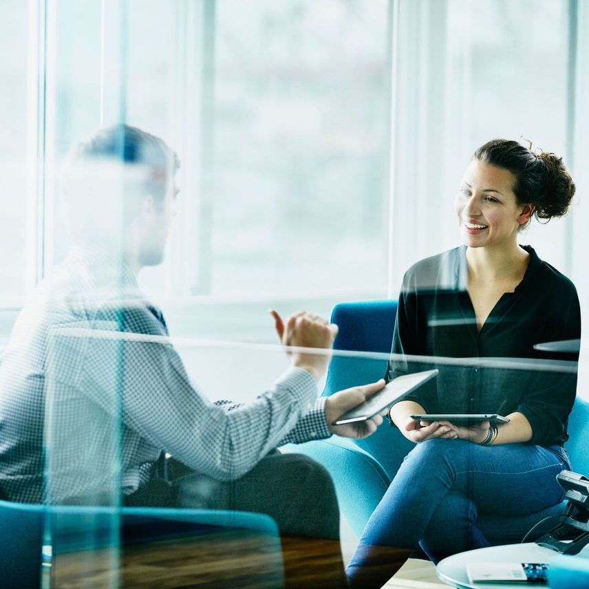 Two people discussing in a meeting room
