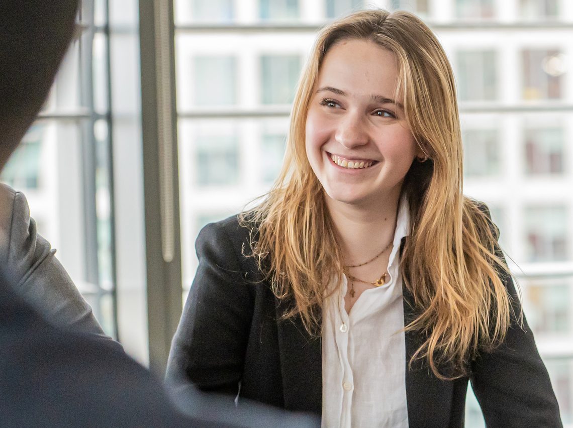 Lady smiling talking to colleagues