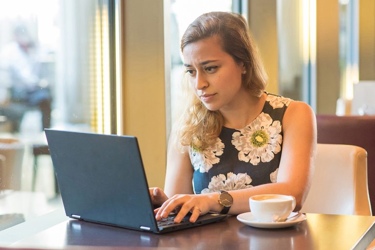 Asian woman working from home with her dog making her company