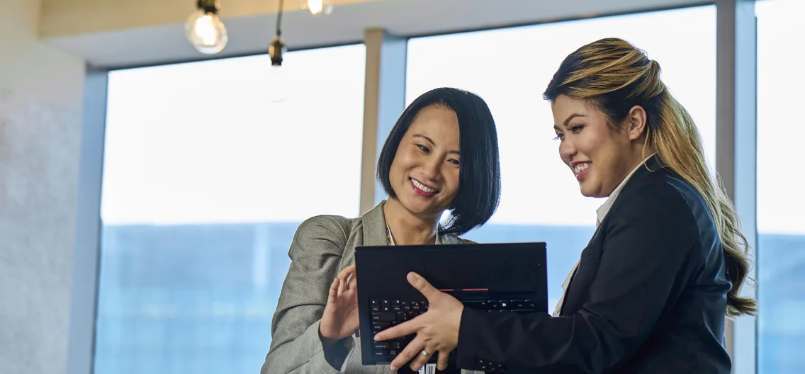 A few women looking at a computer