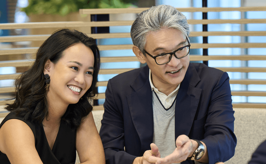 Three people sitting and talking