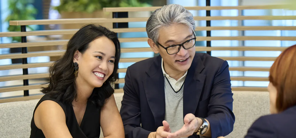 Three people sitting and talking