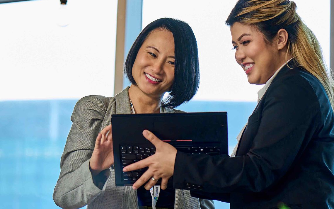 two women looking at a laptop