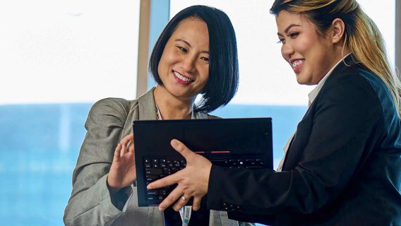 two women looking at a laptop