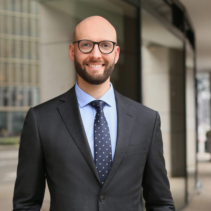 A portrait of Geoff Haeckler smiling outside the office