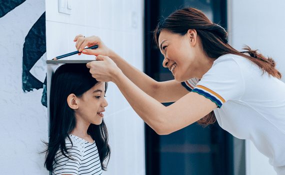 Girl getting height measured