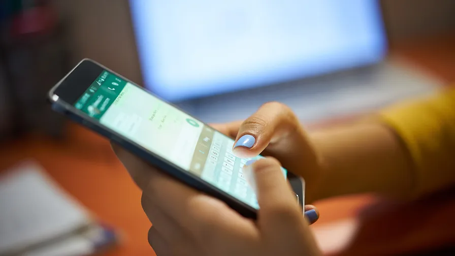 close up of a girl typing on a mobile phone