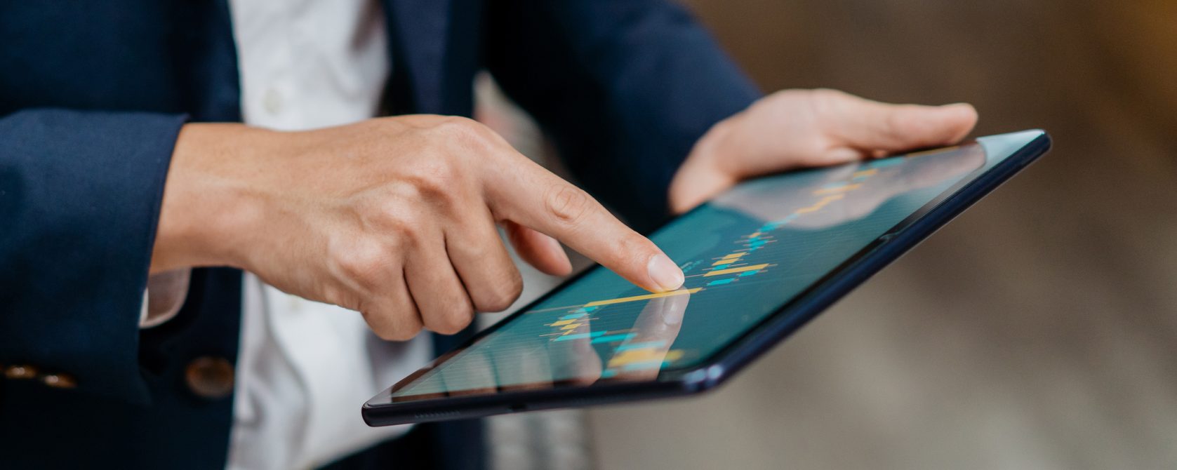 man with a tablet looking at charts
