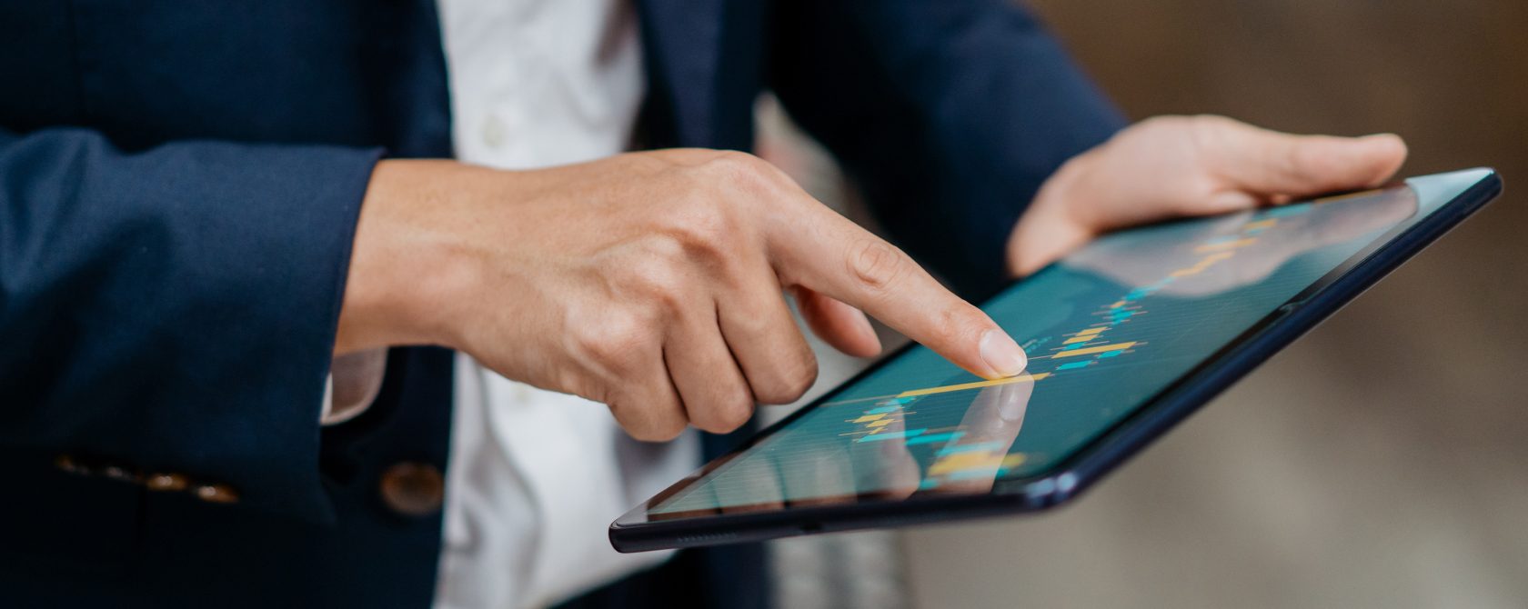 man with a tablet looking at charts