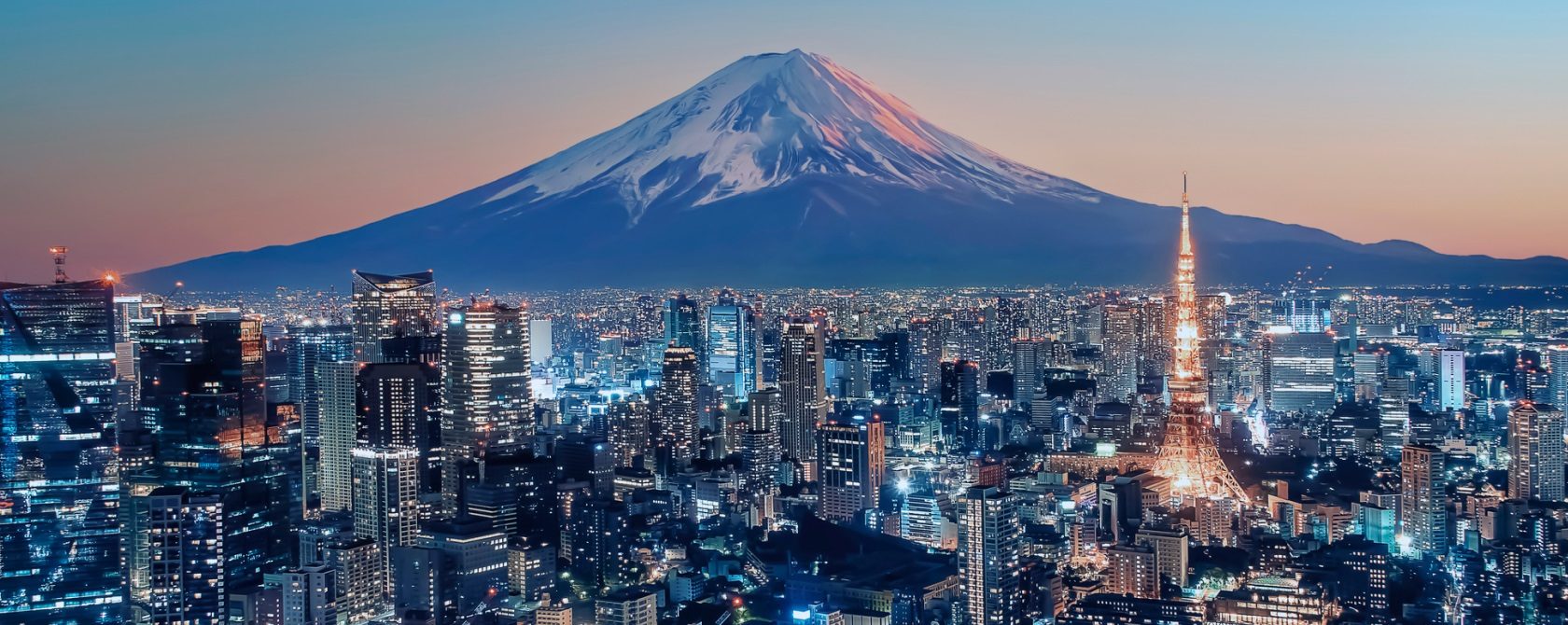 A city full of skyscrapers with a mountain in the backdrop
