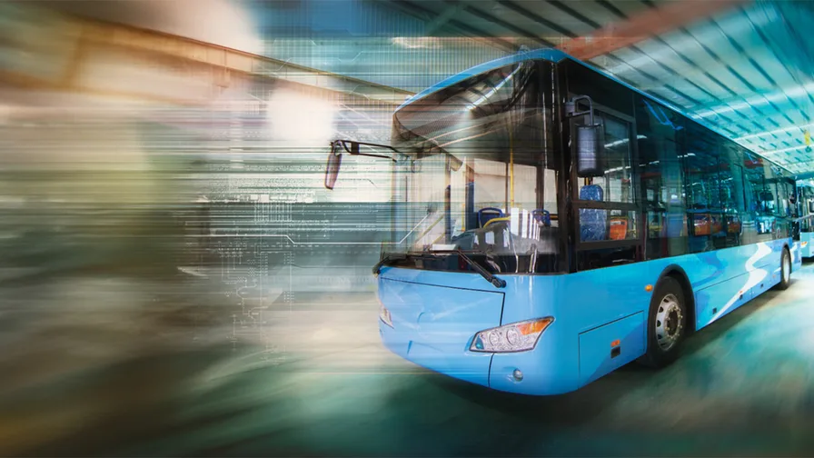 A bus passing by fast on an Indian street