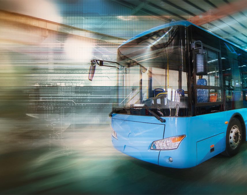 A bus passing by fast on an Indian street