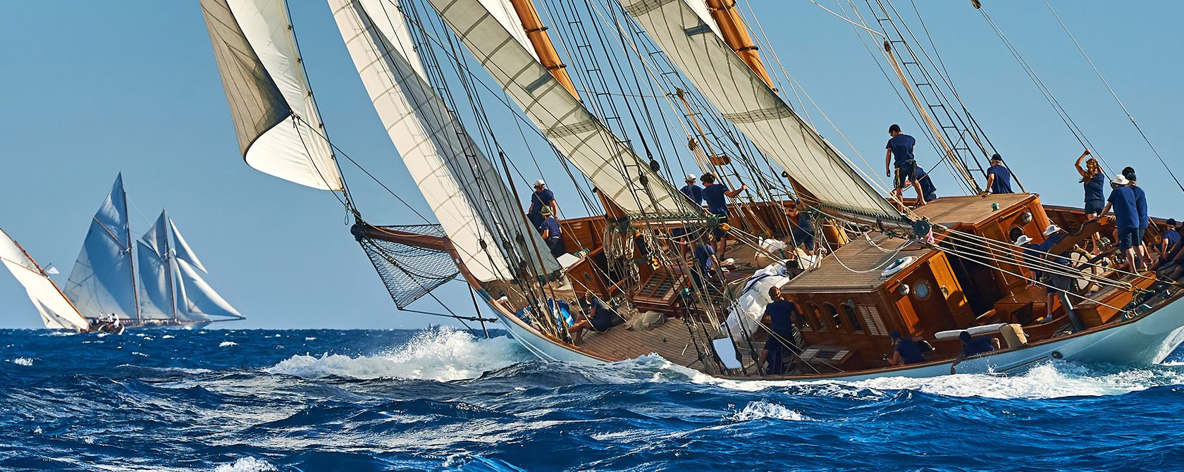 Men sailing a ship that's slanting