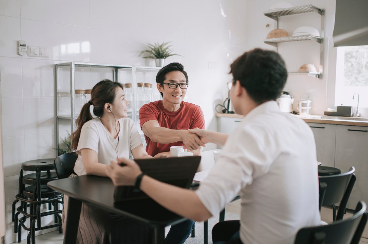 Financier shakes hands with clients