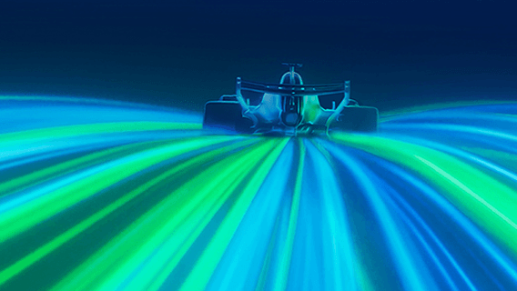 A car rides streaks of blue and green light.