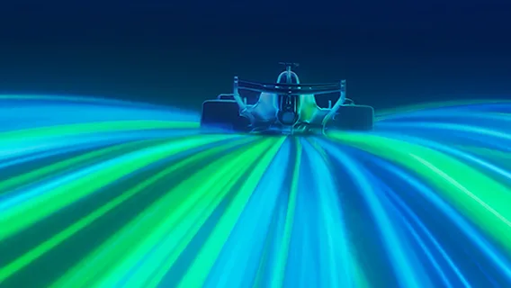A car rides streaks of blue and green light.