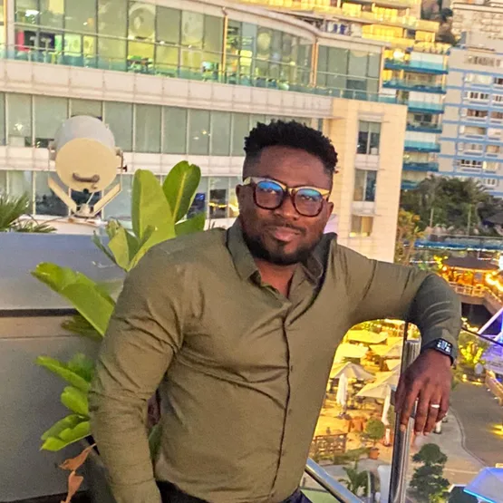 Jamel standing on a balcony