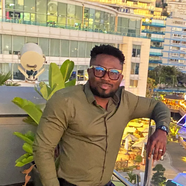 Jamel standing on a balcony