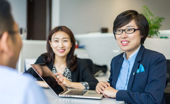 3 people having meeting around table