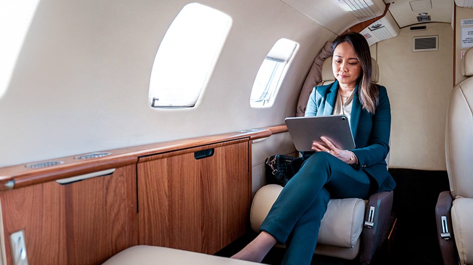 A business woman using a tablet in a private jet