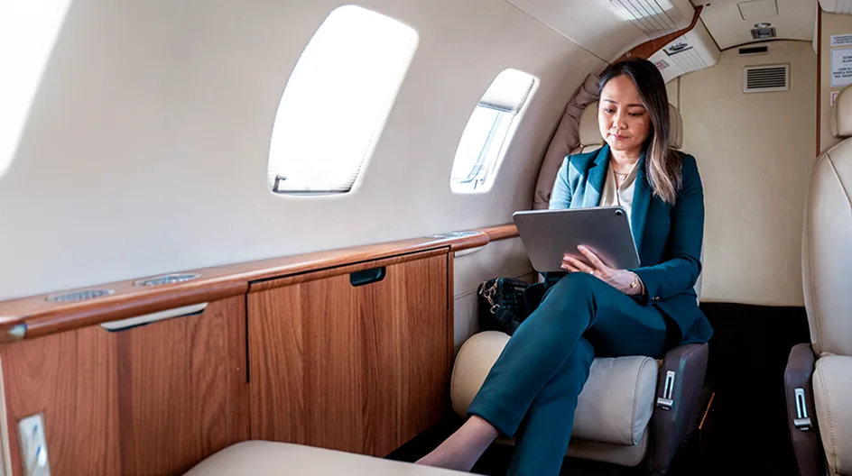 A business woman using a tablet in a private jet