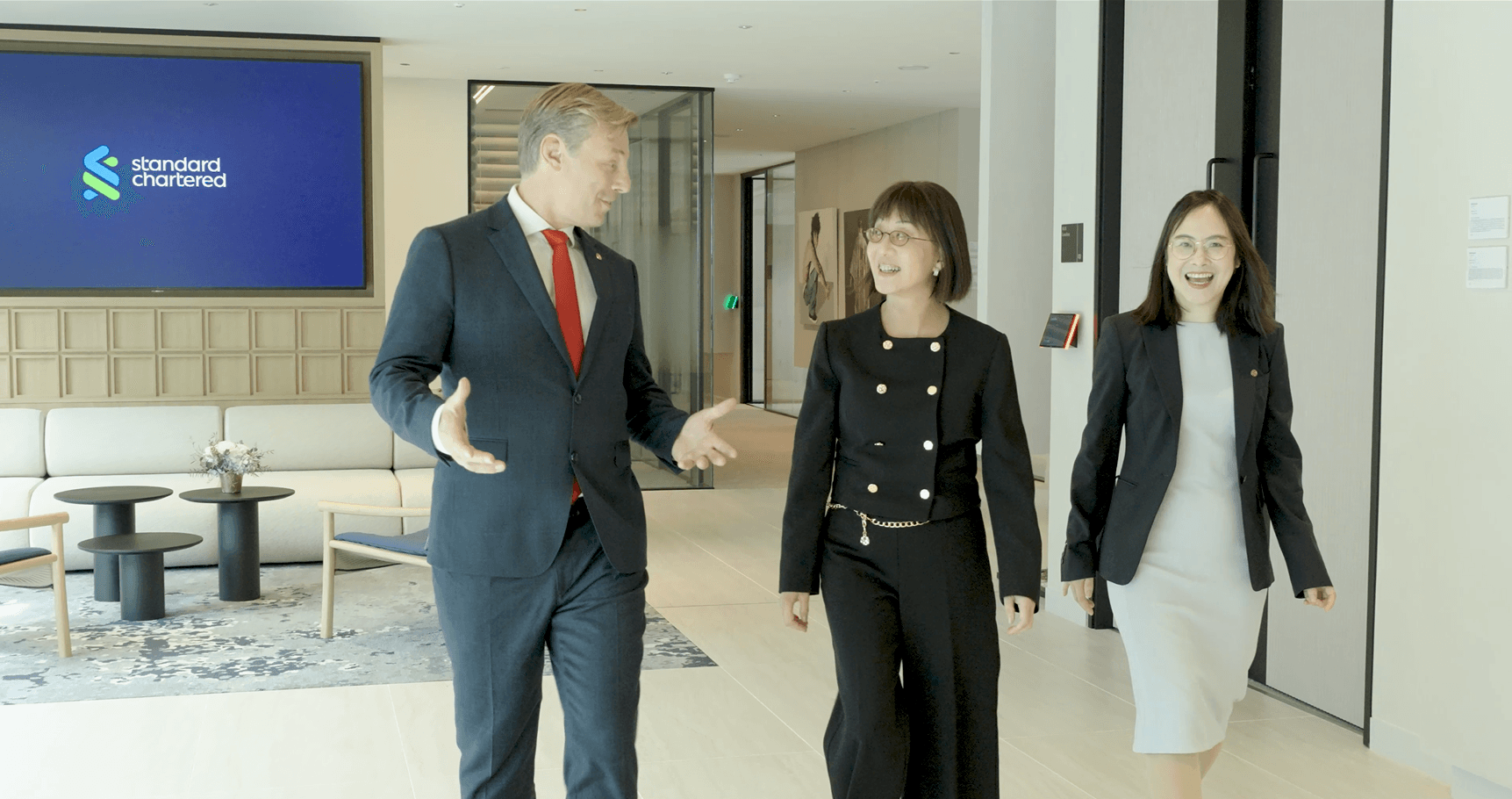 3 business people walking in office