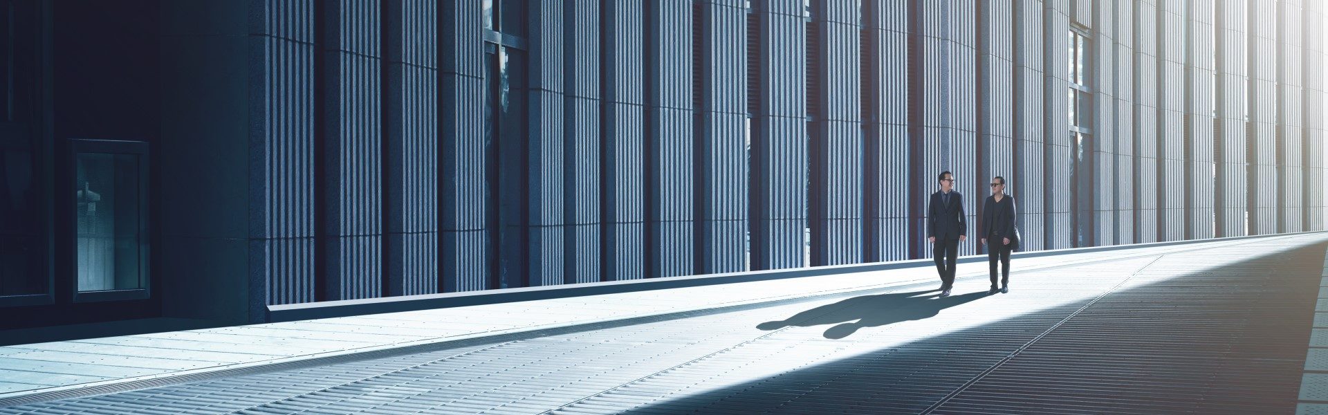 Two businesspeople walking down an alley