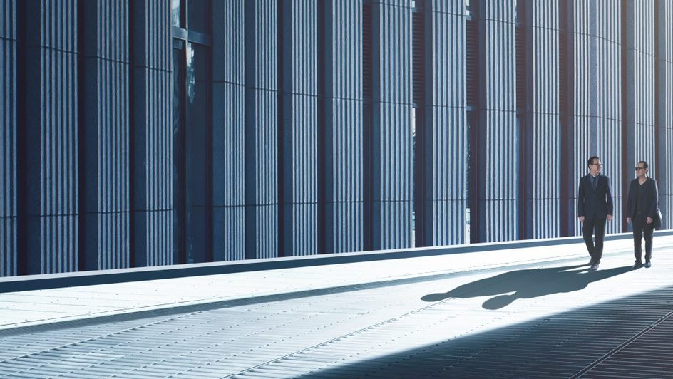 Two businesspeople walking down an alley