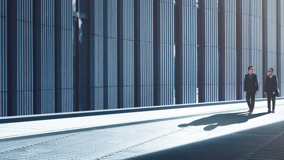 Two businesspeople walking down an alley