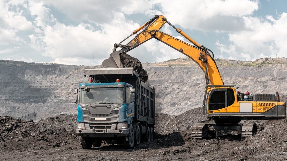 truck and digger in mining site