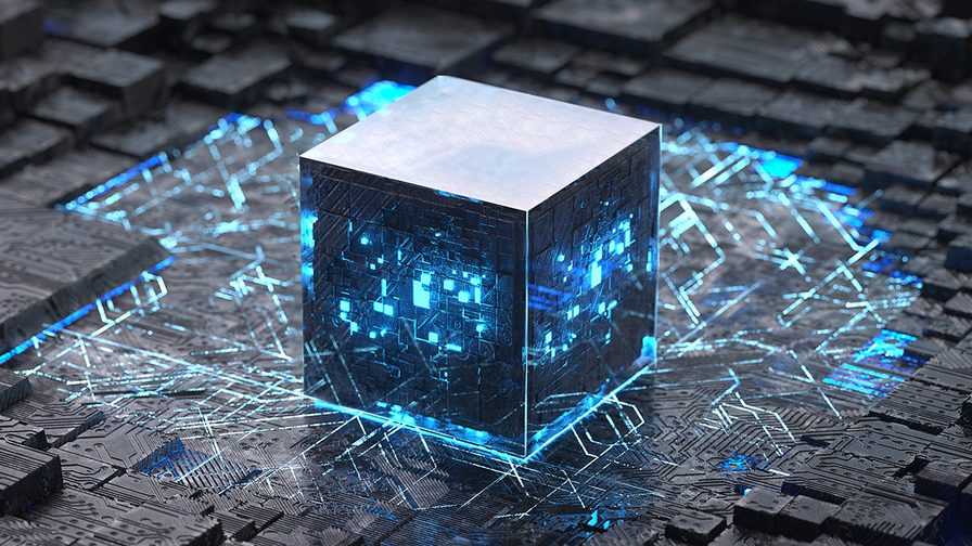 illuminated cube set amongst motherboards and computer chips