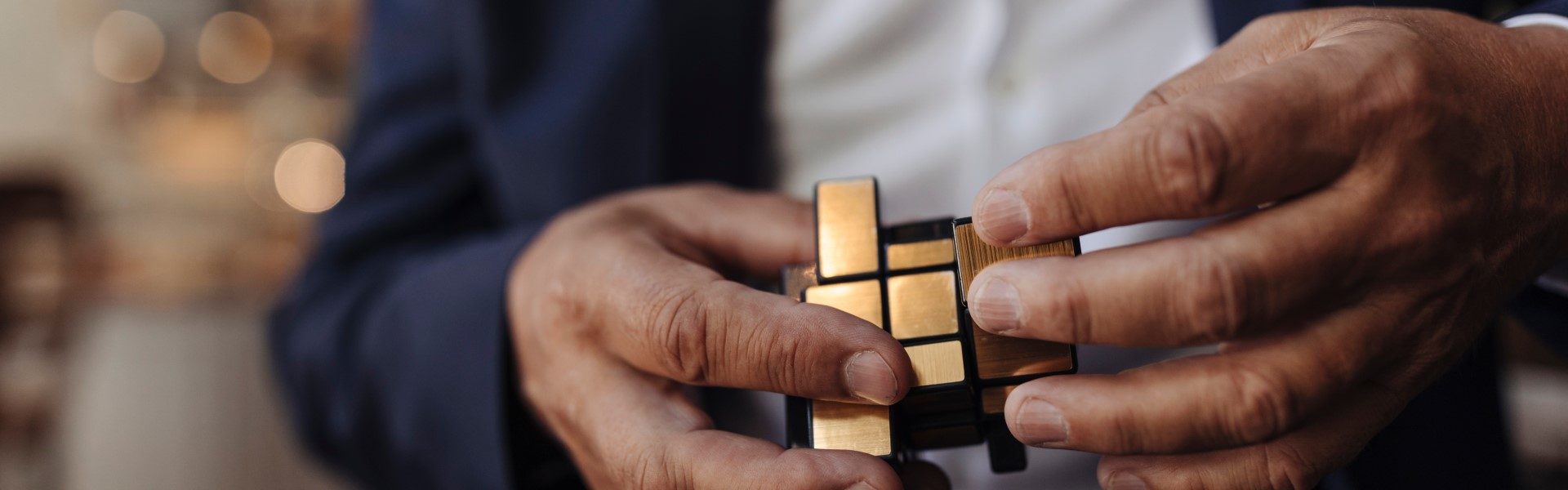 close up image of hands holding a rubiks cube