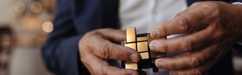 close up image of hands holding a rubiks cube