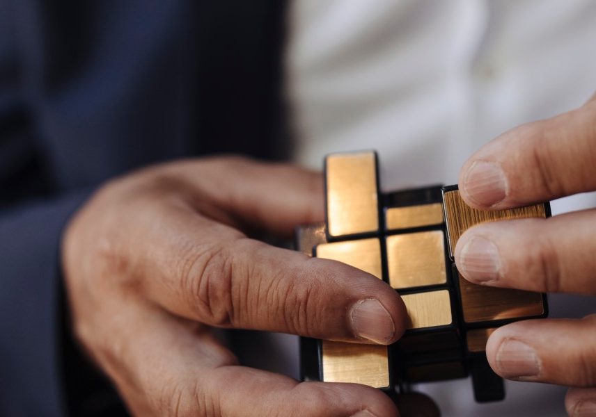 close up image of hands holding a rubiks cube