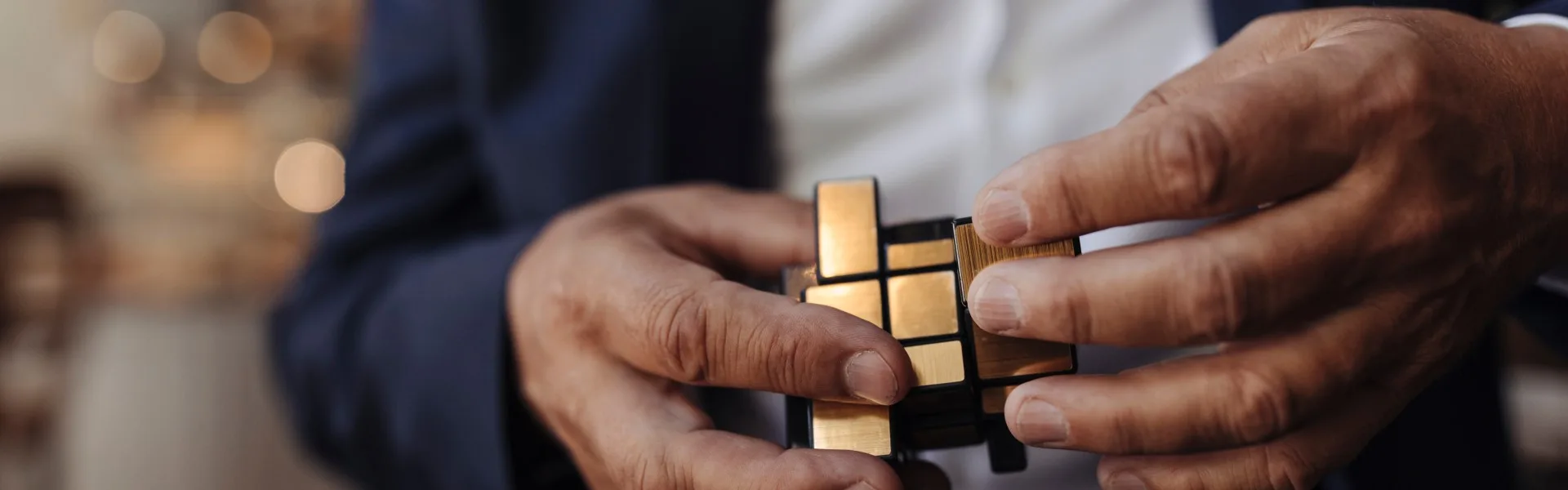 close up image of hands holding a rubiks cube