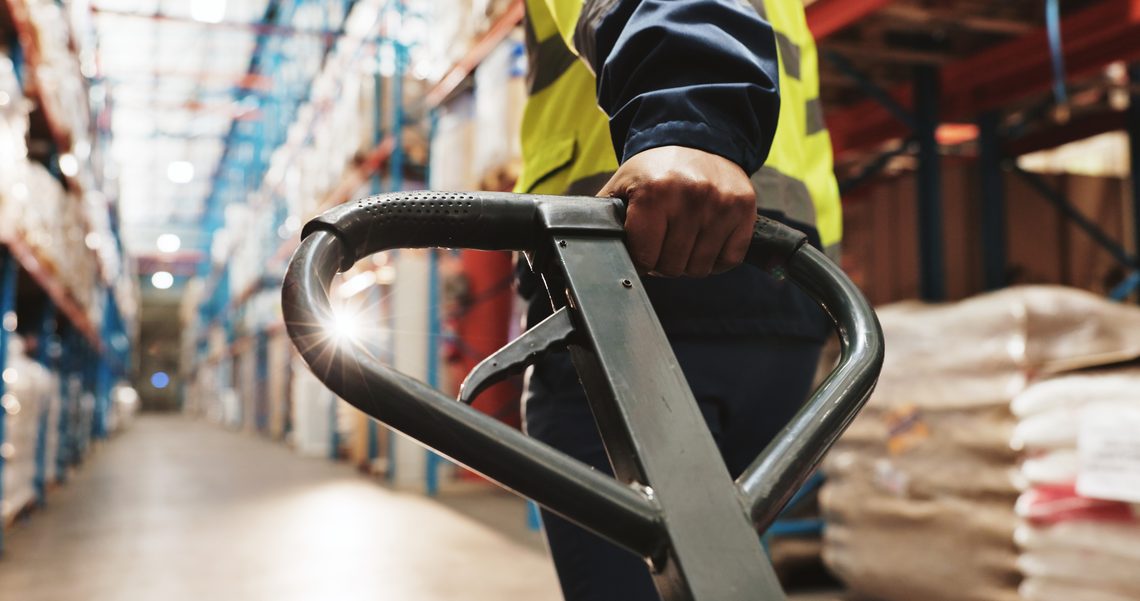 Warehouse worker pulling a trollley