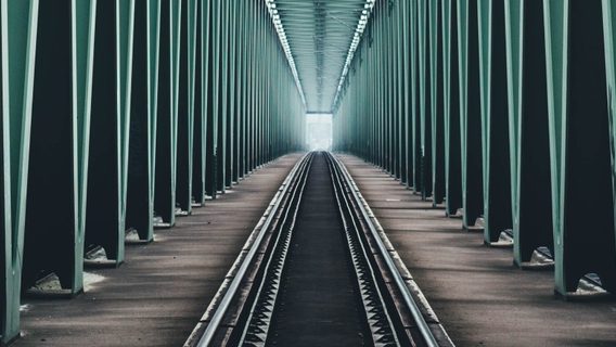 image of train track across a bridge