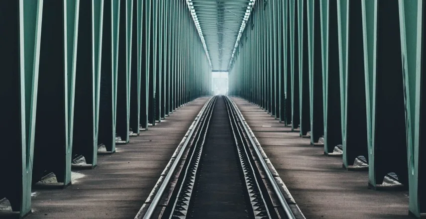 image of train track across a bridge