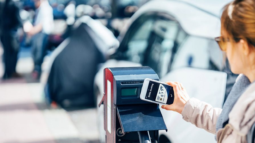 Image of woman making a contactless payment