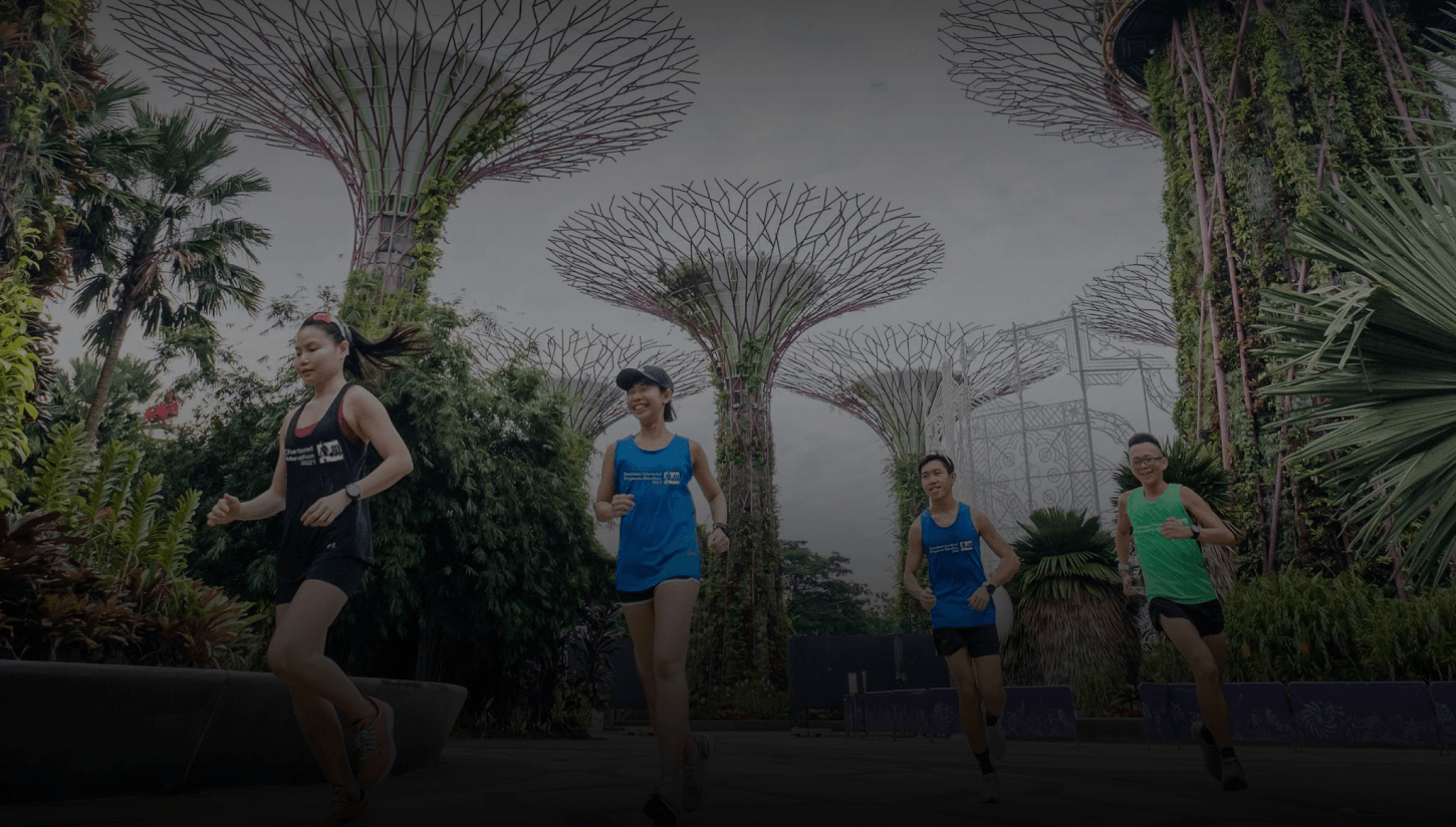Marathon runners jog past the flower sculptures forming part of the Fig Wasp Living Sculpture in Singapore.